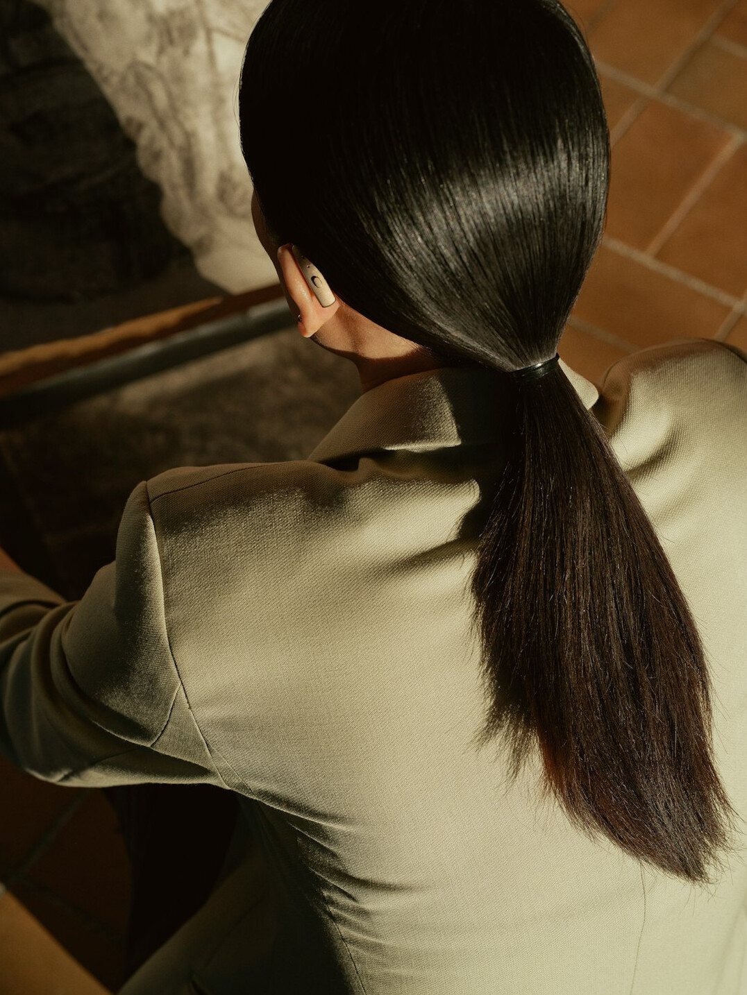 Headshot of a businesswoman with dark hair tied back