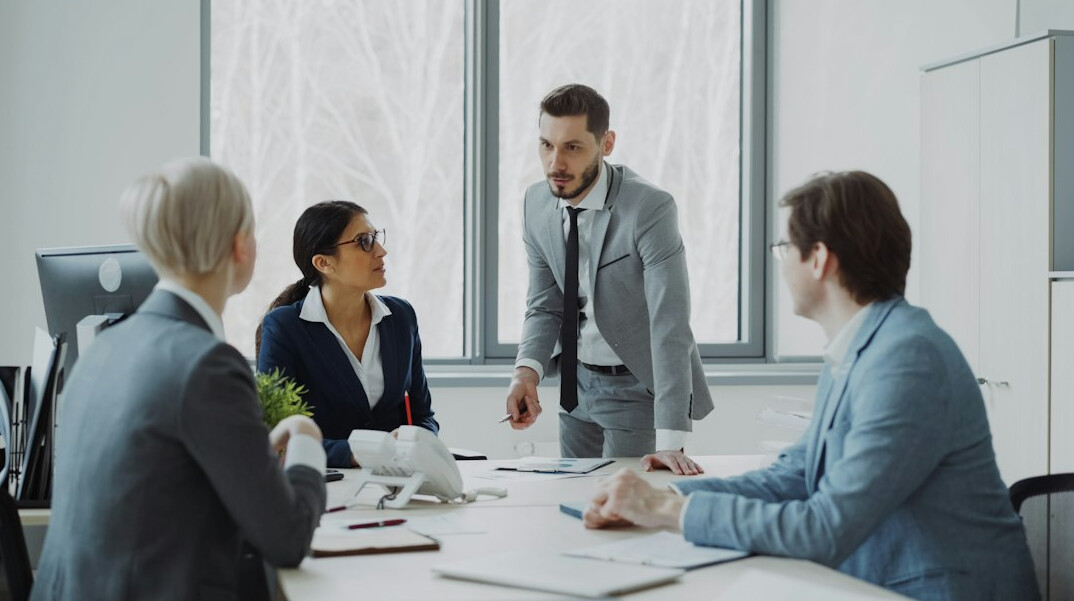 business manager leading team meeting