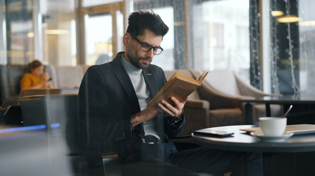 man reading business book