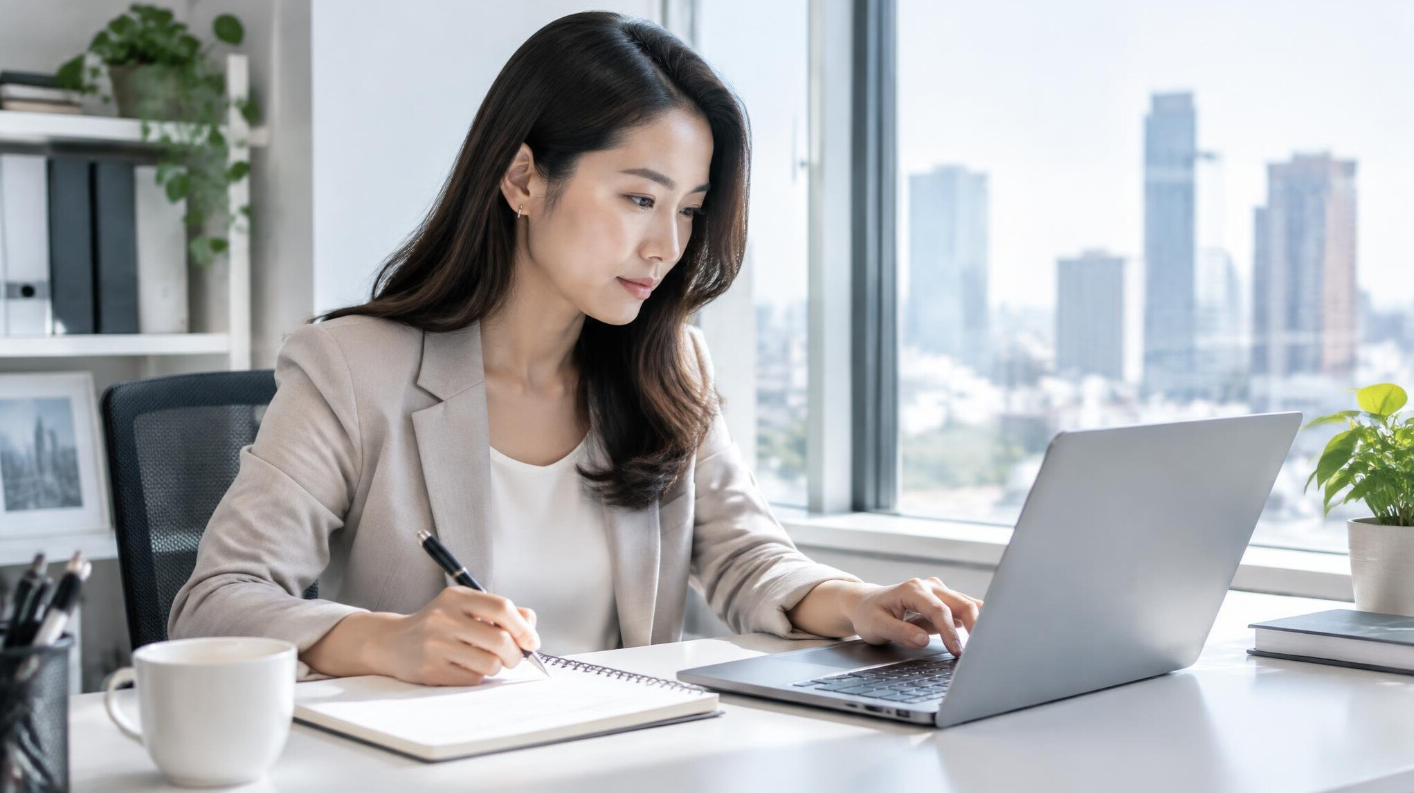 Manager reviewing notes at her laptop
